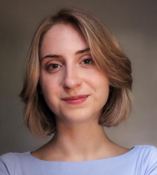 A headshot of Madison Seeman, a blonde woman wearing blue.